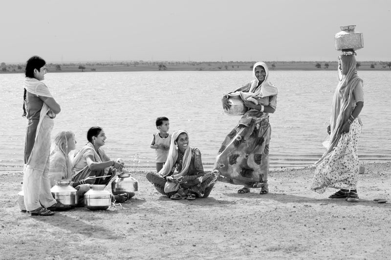 Nature-based solution for quenching thirst in the driest place of India - Women and girls socializing on the cool shores  of Viprasar, a rainfed pond in Thar Desert, Jaisalmer district, Rajasthan